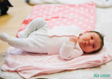 Baby lying on play mat