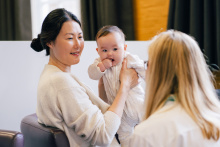 Woman and baby with a peer supporter