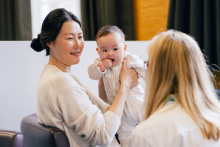 Woman and baby with a peer supporter